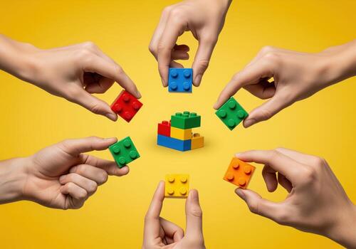 Six hands collaborating to build a structure using colorful interlocking plastic toy bricks. photo