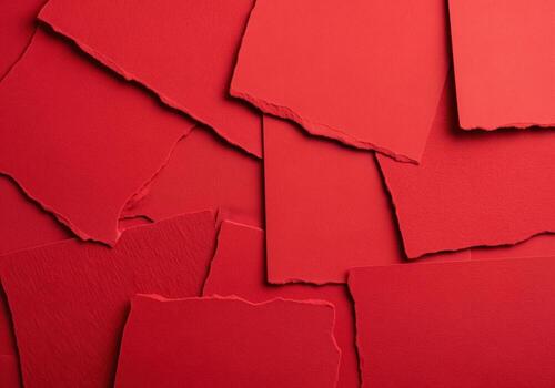 Abstract background of overlapping torn red paper pieces creating a textured crimson collage. photo