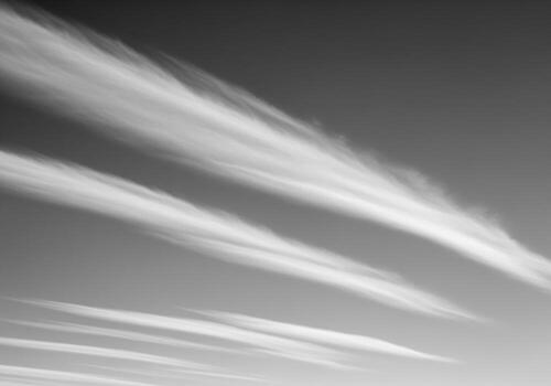 Abstract black and white sky with diagonal cirrus cloud streaks and texture photo