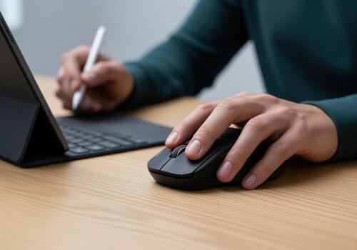 Multitasking professional uses a wireless mouse and stylus pen with a tablet computer setup. photo