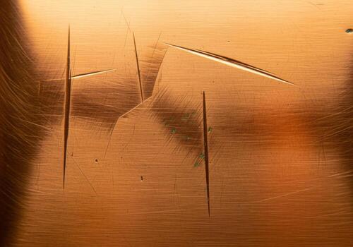 Distressed brushed copper metal texture background with deep scratches and gouges. photo