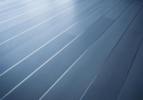 Diagonal perspective of cool toned gray wood plank flooring texture with reflections photo