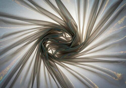 Abstract background of shimmering iridescent organza fabric twisted into a dynamic spiral pattern photo