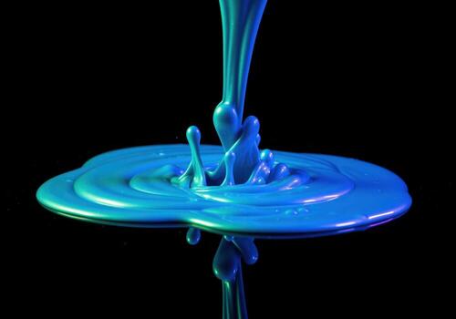 Iridescent blue paint pouring down creating a vibrant splash and abstract fluid motion photo