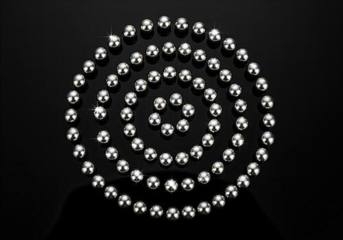 Reflective silver spheres arranged in a perfect concentric spiral on black surface photo