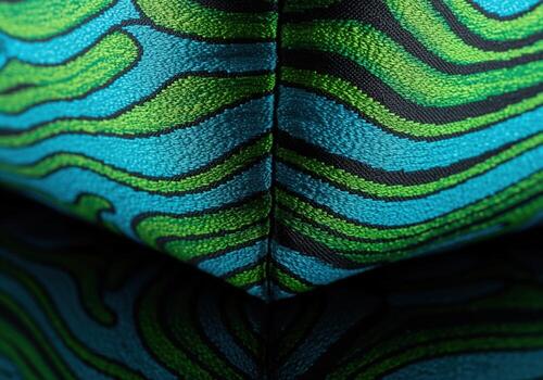 Vibrant abstract wavy pattern on textured silk fabric corner in teal and lime green. photo