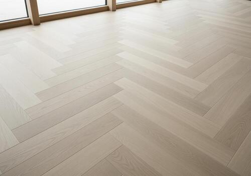 Bright modern wooden floor texture featuring a classic herringbone pattern design photo