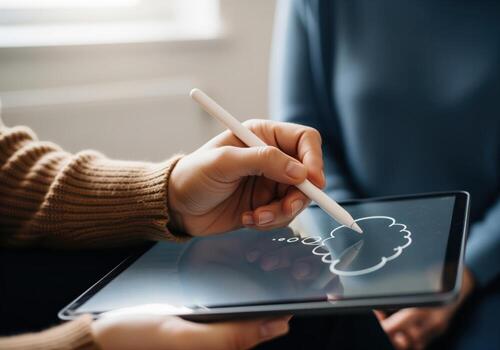 Hand sketching a thought bubble diagram on a digital tablet during a therapy session. photo