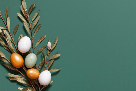 Colorful Easter Eggs Arranged With Willow Branches on a Green Background photo