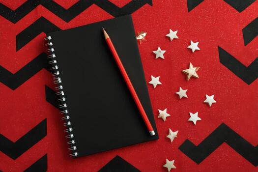 Creative Workspace With Blank Notebook and Pencil on Red Background Decorated With Stars photo