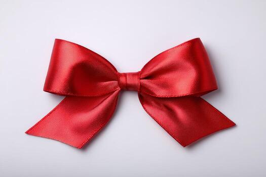 Elegant Red Satin Bow With Ribbon on a Plain White Background Ready for Gifting photo