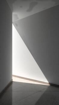 Light Creates a Geometric Triangle Shape on a Minimalistic Concrete Floor in an Empty Room photo