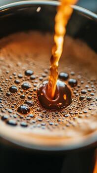 Coffee Pours Into a Black Cup Creating Bubbles and a Rich Texture in a Cozy Setting photo