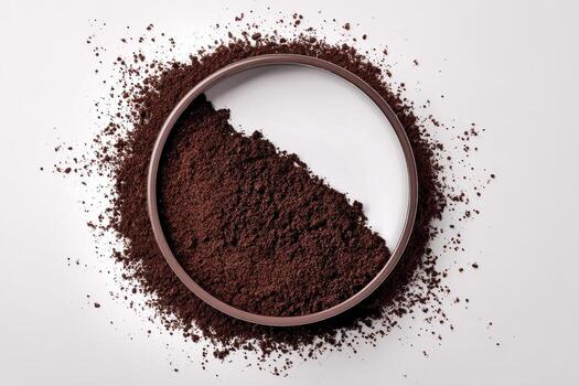 Ground Coffee Spread on a White Surface Creating a Circular Pattern photo