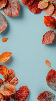 Colorful Autumn Leaves Border on a Soft Blue Background Creating a Warm Seasonal Display photo