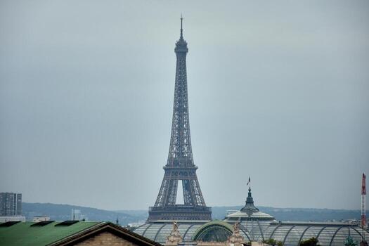 Eiffel Tower in the background from the terrace of Galeries Lafayette in Paris with urban rooftops and Parisian architecture photo