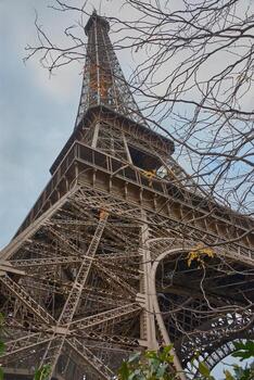 The metal structure of the Eiffel Tower in Paris, built in 1889, as a symbol of innovation under an overcast sky photo