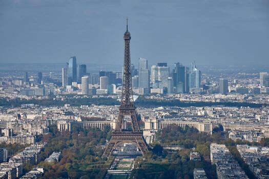 Aerial view of Paris with the Eiffel Tower in the foreground and the La Defense business district in the background on a clear day photo
