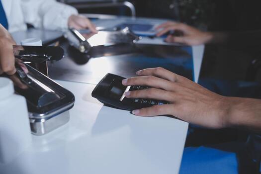 Person using a calculator on the table photo