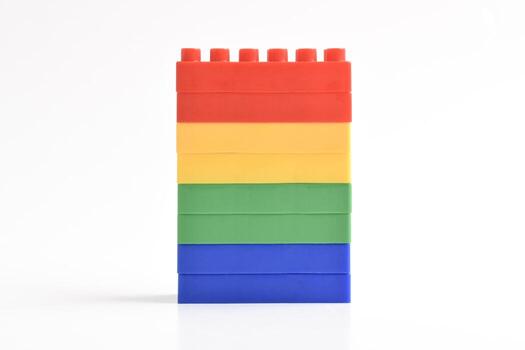 Stack of Colorful Building Blocks in Rainbow Order on White Background. photo