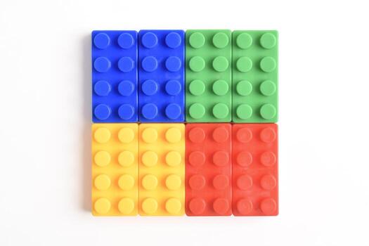 Four Colorful Building Blocks Arranged in a Square on White Background. photo