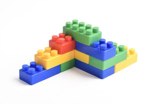Colorful interlocking building blocks stacked in a playful, abstract structure on a white background. photo