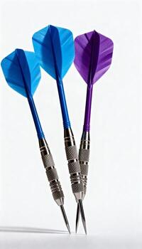 Three colorful darts standing balanced on a white background photo