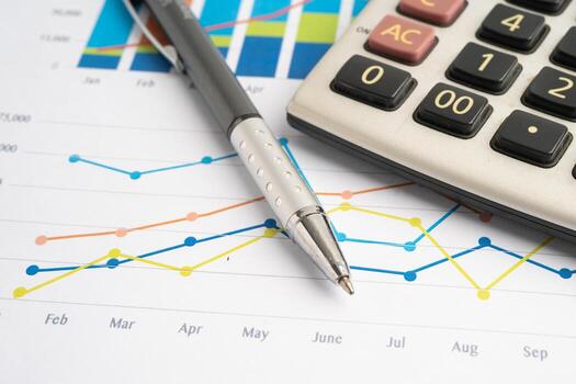 Pencil and calculator on chart or graph paper. Financial, account, statistics and business data. photo
