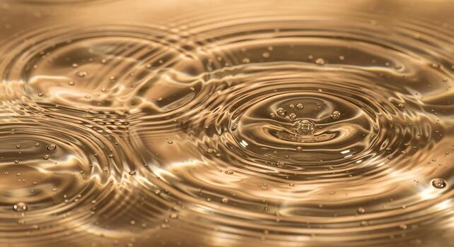 Close-up of golden liquid with concentric ripples and bubbles, creating a mesmerizing abstract pattern photo