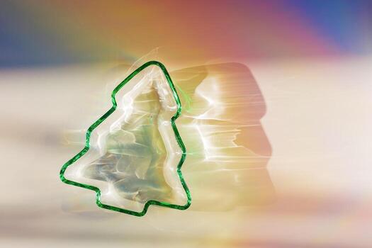 New Year tree, Christmas fir tree from transparent green colored glowing glass at sunbeams, caustics effect, star filter. Bright sunlight and shadows, sparkling texture, rainbow colorful photo