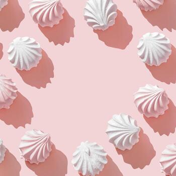 Frame from Pink and White zephyr, marshmallow on Pastel Pink Background, Top view close up of swirled meringue cookies with sun shadows, minimal flat lay pfoto of sweet dessert, sweetness, copyspace photo