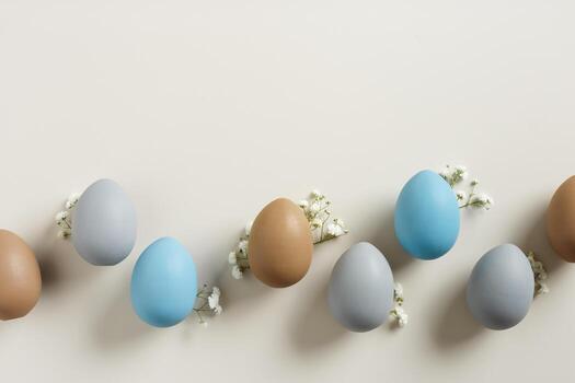 Elegant Easter flat lay with Pastel Eggs and Spring Blossoms, still life Dyed eggs in soft pastel colors, top view spring holiday minimal creative pattern, neutral earth colored image, above photo