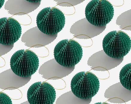 Top view of green honeycomb paper Christmas ornaments in minimal trend pattern on light gray background. Bright New Year balls with sun shadows, linear, graphic print modern holiday themes. photo