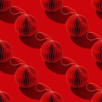 Top view of red paper Christmas ornaments in minimal Seamless pattern, red monochrome. Bright New Year balls with sun shadows. Festive Holiday Packaging Design, gift wrapping paper, textile design. photo