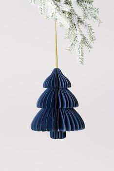 Minimal Christmas fir tree ornament of eco-friendly blue paper hanging on golden string on snowy pine branch on light gray background. Festive Winter holidays xmas decor, side view, minimal design. photo