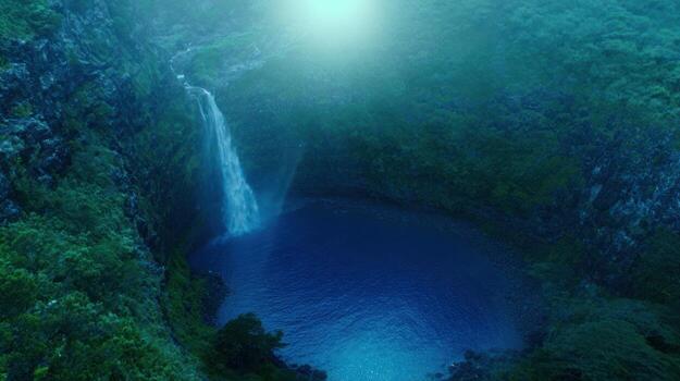 Waterfall cascading into a serene pond surrounded by greenery photo