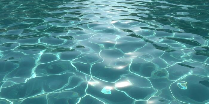 Close up view of clear turquoise water surface with sunlight reflections and ripples creating an abstract background photo