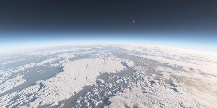 An awe inspiring view of Earth from space with its curved horizon and dense white clouds under a dark sky featuring a crescent moon photo