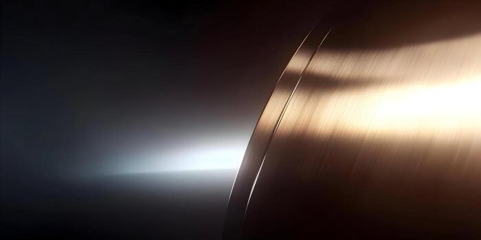A dark background is illuminated by a radiant light source reflecting off a curved metallic surface creating an elegant abstract design photo