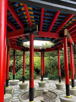 Vibrant Red Pagoda Gazebo in a Lush Japanese Garden photo