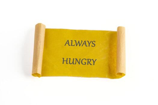 A golden scroll unfurls, its message stark. The words ALWAYS HUNGRY are displayed, a constant craving etched onto the parchment. A state of endless appetite photo