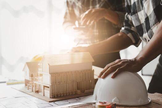 Architecture team drawing something while working with blueprint in the office. Architecture and Engineer concept photo