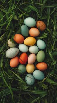Colorful Easter eggs scattered on green grass in a vibrant spring display. photo