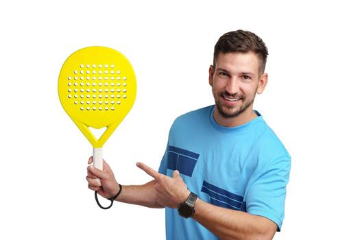 Man smiles and points at a bright yellow paddle in a studio setting photo