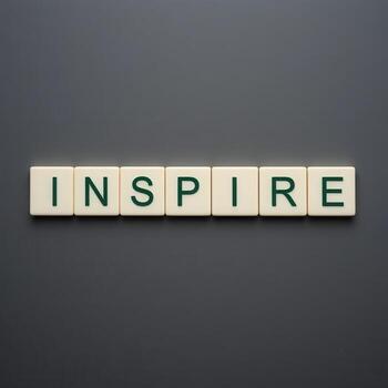 Inspire Word on Tiles with Dark Background for Motivational Themes photo