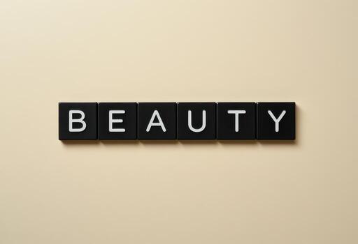 Concept of Beauty spelled out with Alphabet Tiles on a minimalistic background photo