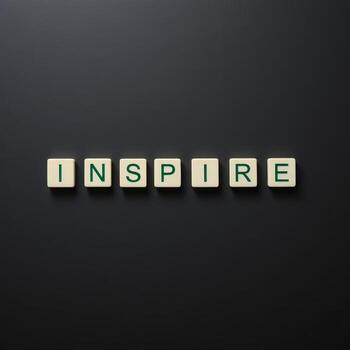 Inspire Message Created with Letter Blocks on Dark Surface Background photo