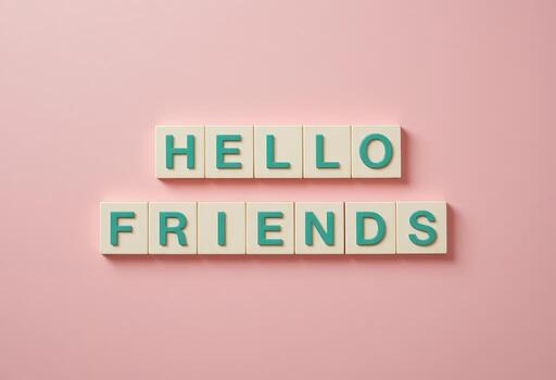 Colorful Alphabet Tiles Spelling Hello Friends on a Soft Pink Background photo