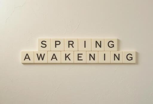 Spring Awakening Text Letter Tiles on Neutral Background for Season Concept photo