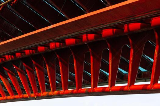 Red architectural bridge with intricate design and structural patterns photo